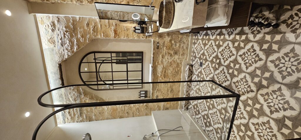 The bathroom is all sleek and steel at Stoes